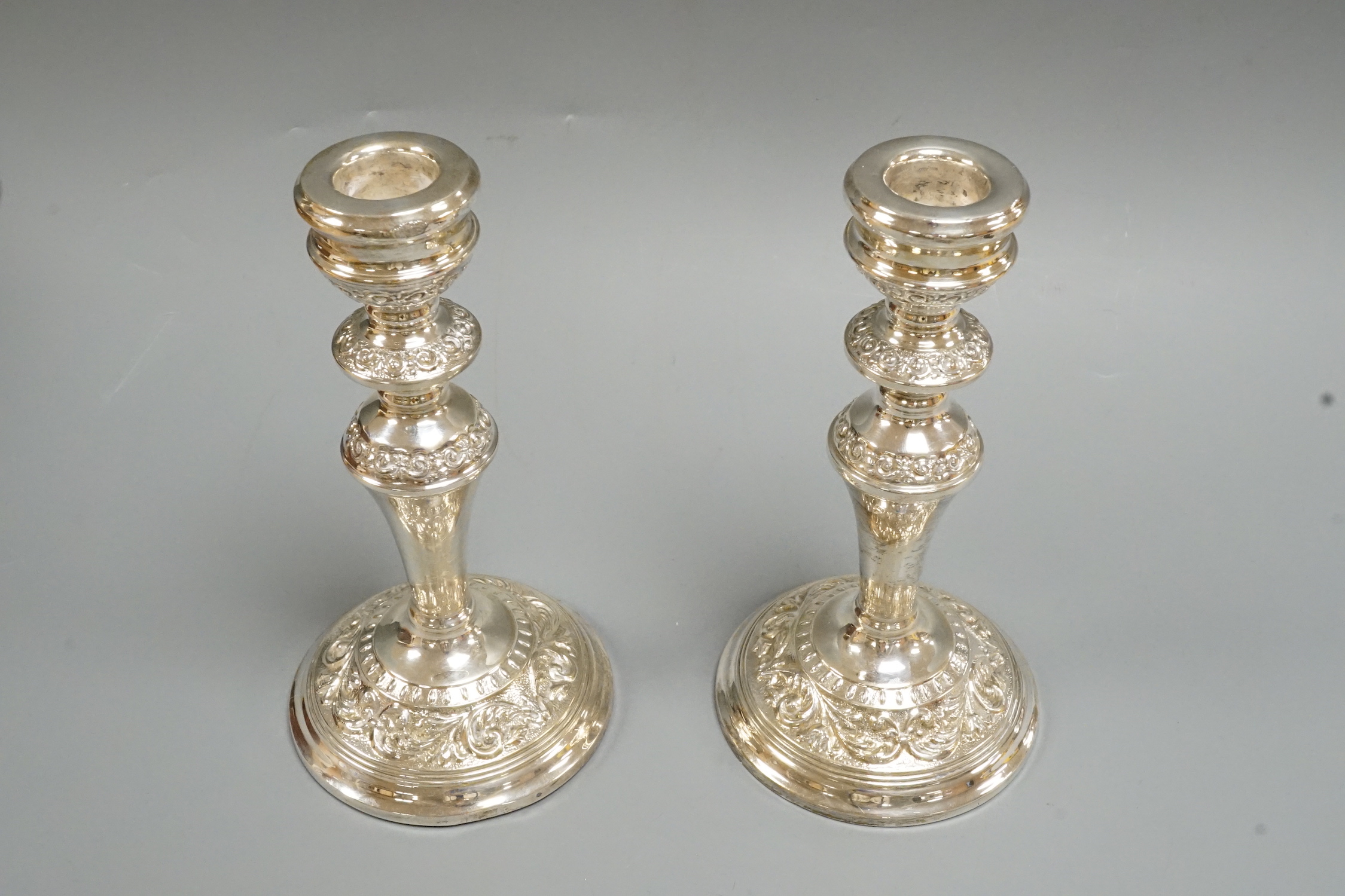 A pair of Elizabeth II silver mounted candlesticks, W.I. Broadway & Co, Birmingham, 1965/66, height 18.9cm.